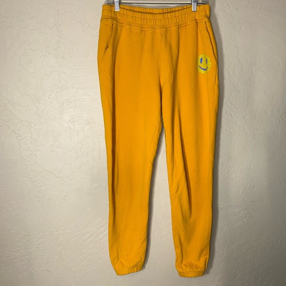Outdoor voices smiley face sweatpant joggers in mustard yellow.